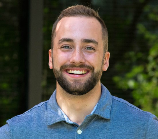 Luke Melenberg, smiling, photographed outdoors